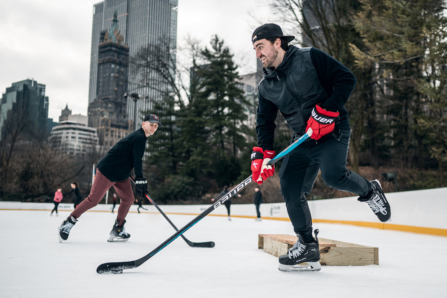 man playing hockey on outdoor ice rink in new york city