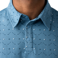 Close-up of a blue patterned polo shirt with a collar and buttons.