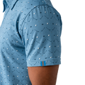 Blue polo shirt with golf pattern on a white background