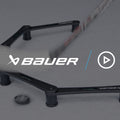 a hockey player stickhandling and passing a puck through the gates of an electronic stickhandling tool
