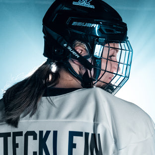 Stecklein portrait in hockey gear with head turned to the side